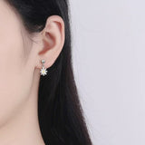 Daisy Dangle Earrings on Ear