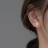 Gold Daisy Earrings on Ear