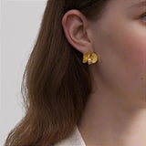 Gold Orchid Earrings on Ear