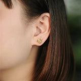 Gold Rose Earrings on Ear
