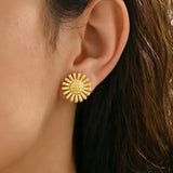 Gold Sunflower Earrings on Ear