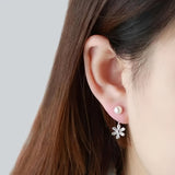 Silver Daisy Drop Earrings on Ear