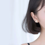Silver Sunflower Earrings on Ear