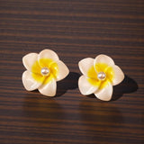 White Plumeria Earrings on Wood Surface
